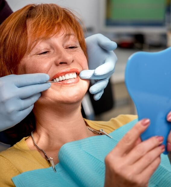 Woman with dental implant supported replacement tooth smiling