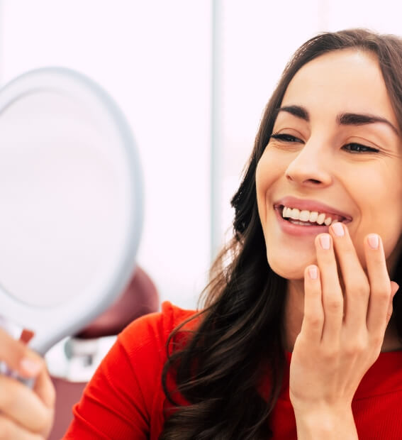 Woman enjoying flawless smile after dental implant tooth replacement