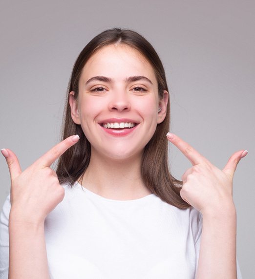 woman smiling after undergoing Invisalign in Plano
