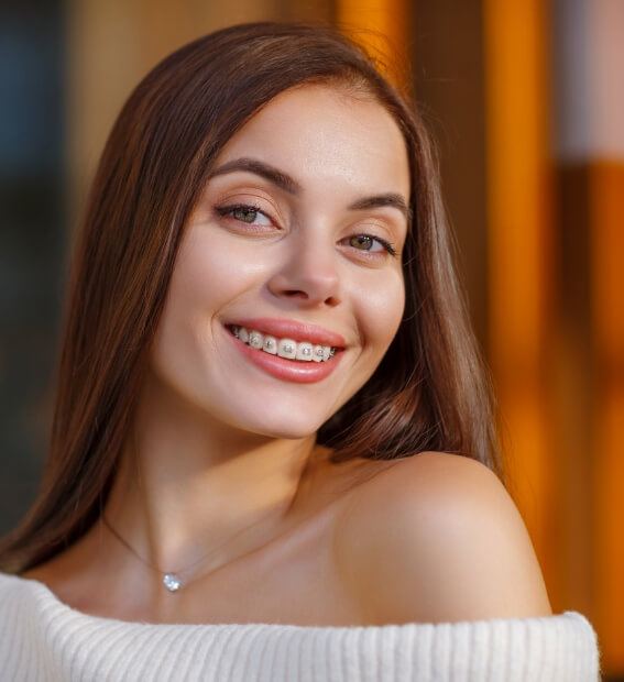 Smiling teen with traditional orthodontics