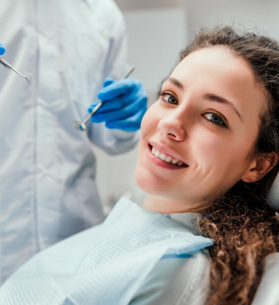 Woman smiling during preventive dentistry checkup and teeth cleaning
