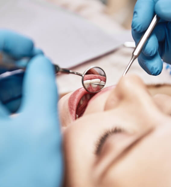 Dentist performing an oral cancer screening
